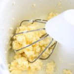 Freshly churned butter in a stand mixer sitting in watery buttermilk