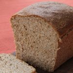 A sliced loaf of whole wheat bread