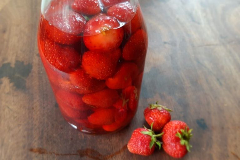 A jar of fermenting strawberries, turning into a strawberry vinegar