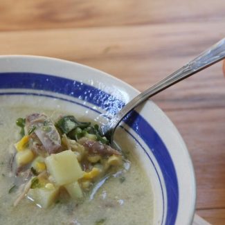 a spoonful of duck and corn chowder