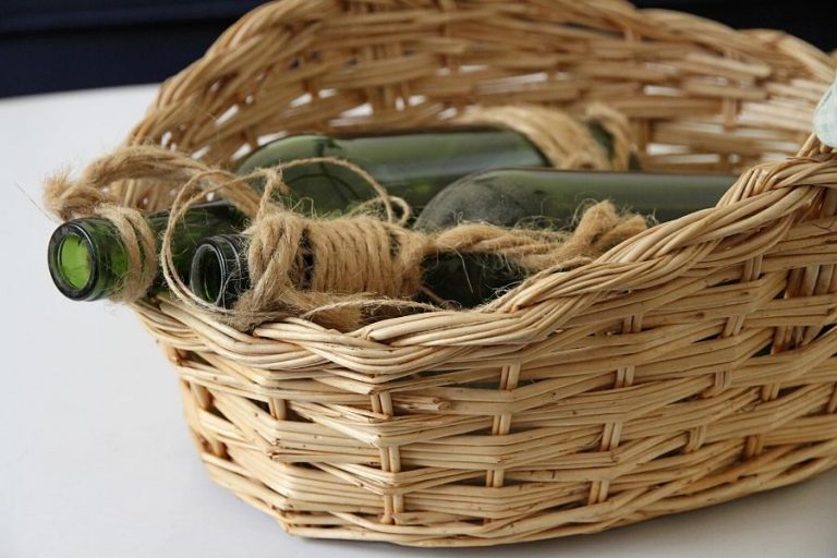 a basket holding two green bottles