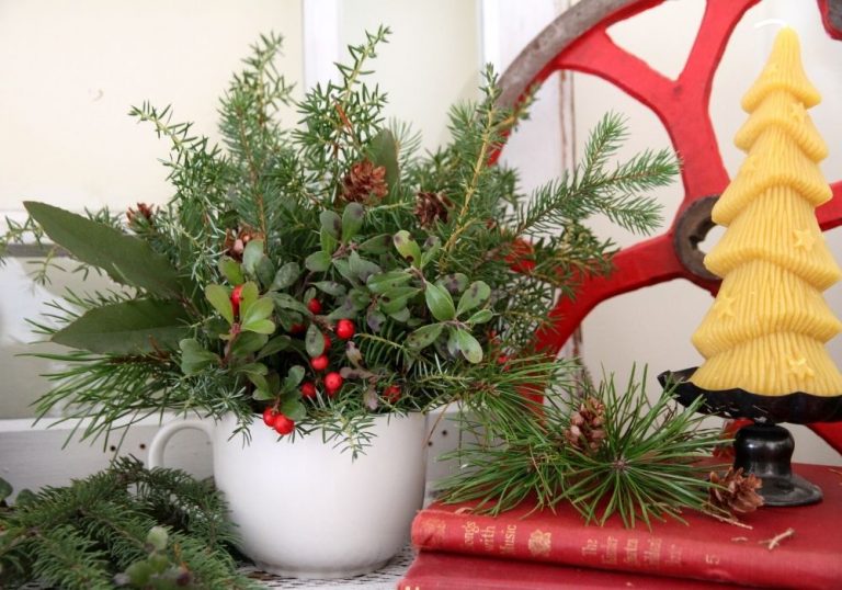 Greenery and red berries arranged in a Christmas bouquet