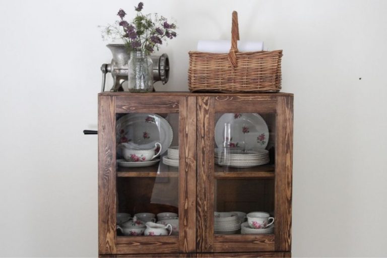A wooden hutch with glass doors