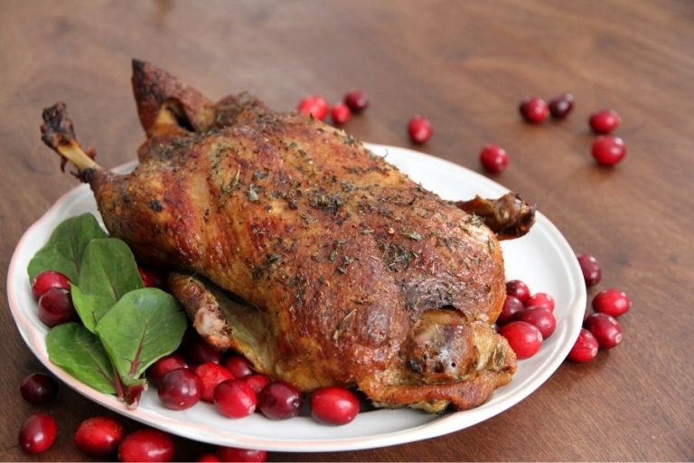A steaming hot, roasted duck ready for carving