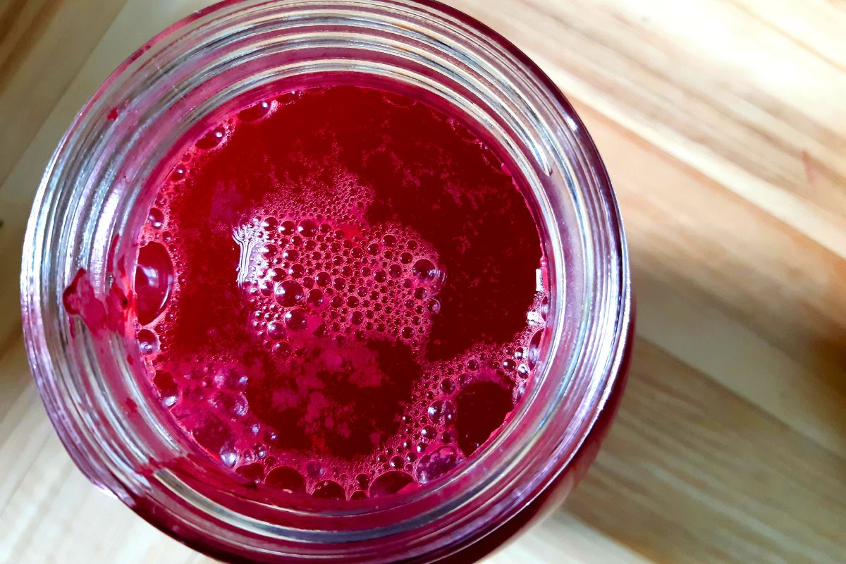 A jar of fully fermented and strained red, beet kvass. 
