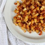 a white plate with a heaping pile of parsnips chunks roasted golden