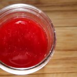 a jar of red strawberry juice with tiny bubbles on it's surface, a sure sign of natural yeasts at work