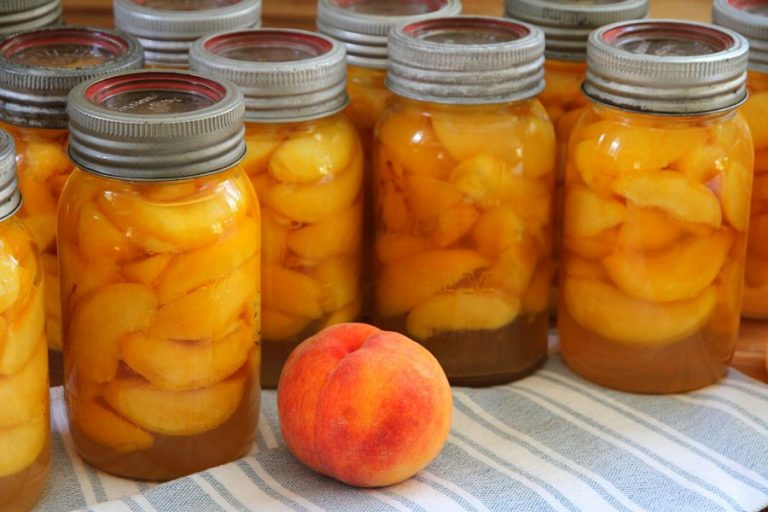 quart jars filled with home canned peaches