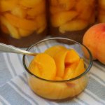 a bowl of peaches canned with honey