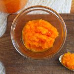 a bowl and spoon filled with chunky fermented sweet pepper sauce