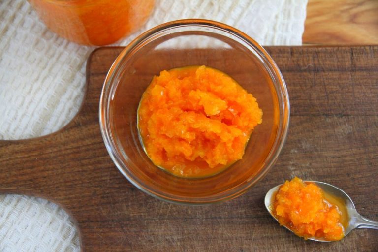 a bowl and spoon filled with chunky fermented sweet pepper sauce