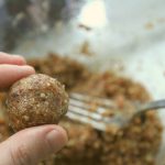 a round, freshly rolled ball of apricots, nuts and cranberries