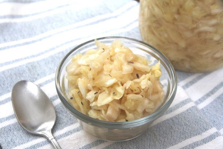 a small glass bowl filled with cabbage, garlic and dill sauerkraut