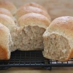 whole wheat dinner buns, separated to reveal fluffy interiors