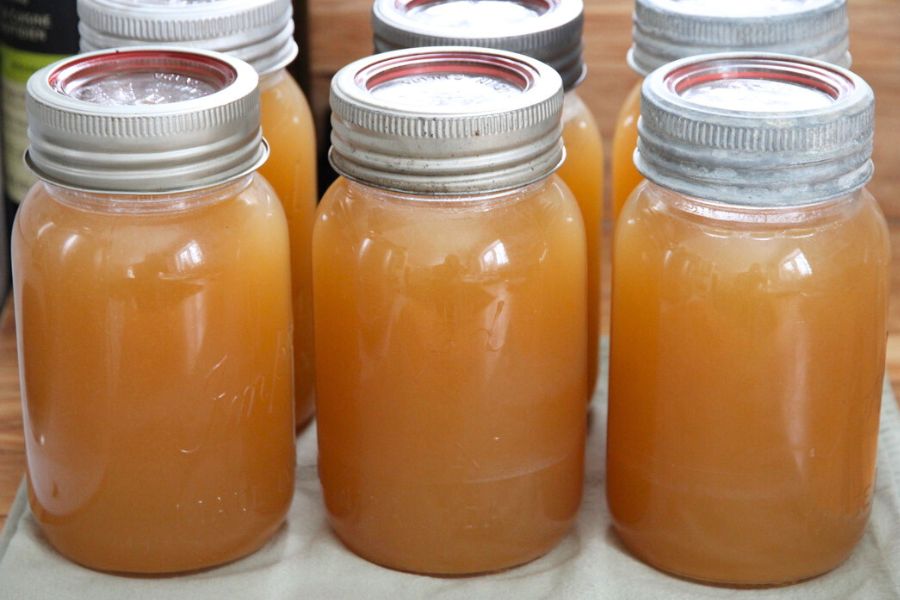 Glass jars filled with rich venison bone broth.
