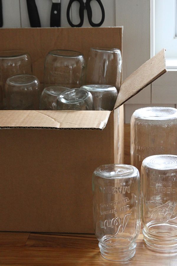 A box of jars ready to be unpacked and store on a shelf.