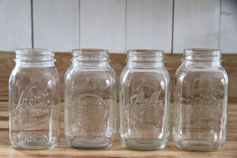 A row of quart jars with different company logos.