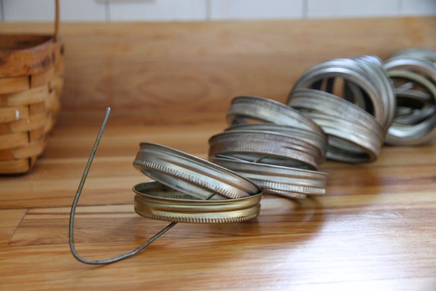 Wide mouth canning rings strung on a wire hanger.