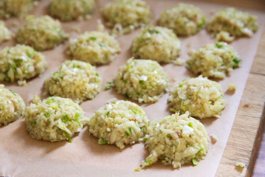 Pats of pureed garlic on parchment paper.