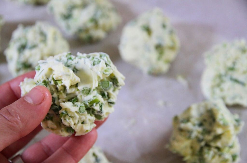 Holding a frozen pat of compound garlic scape butter