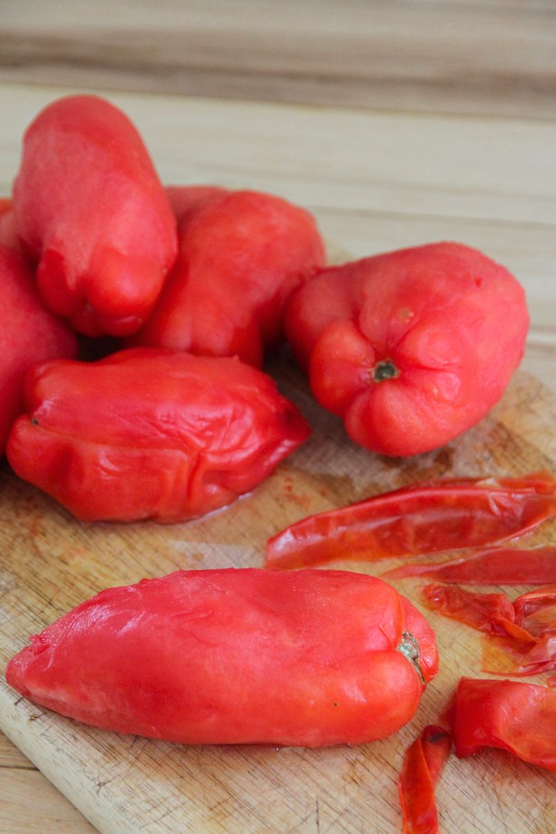 Frozen peeled tomatoes heaped high on a wood cutting board.