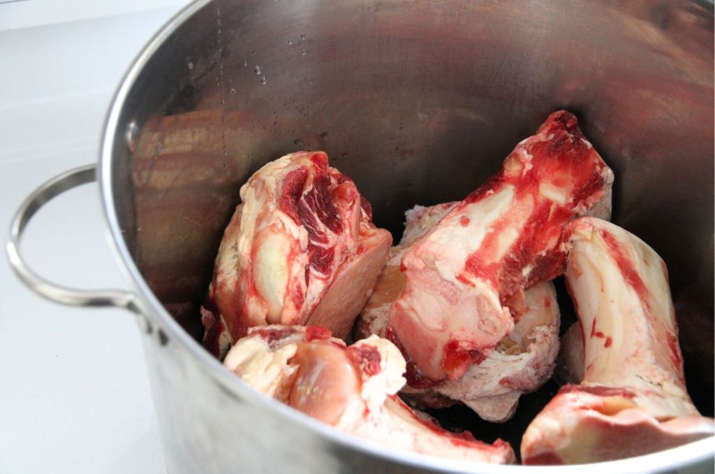 Large beef bones cut to size in a large stock pot.