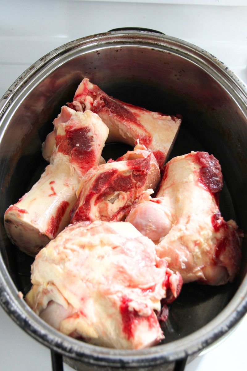 Large knuckle bones in a large oven roaster, ready for the addition of water.
