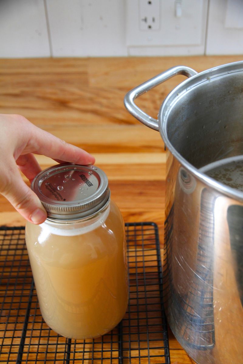 Tightening down the lid of a filled jar with my fingertips.