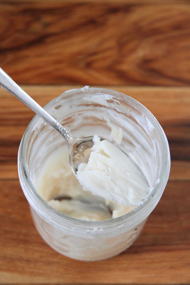 A glass jar filled with rendered lard for seasoning cast iron.