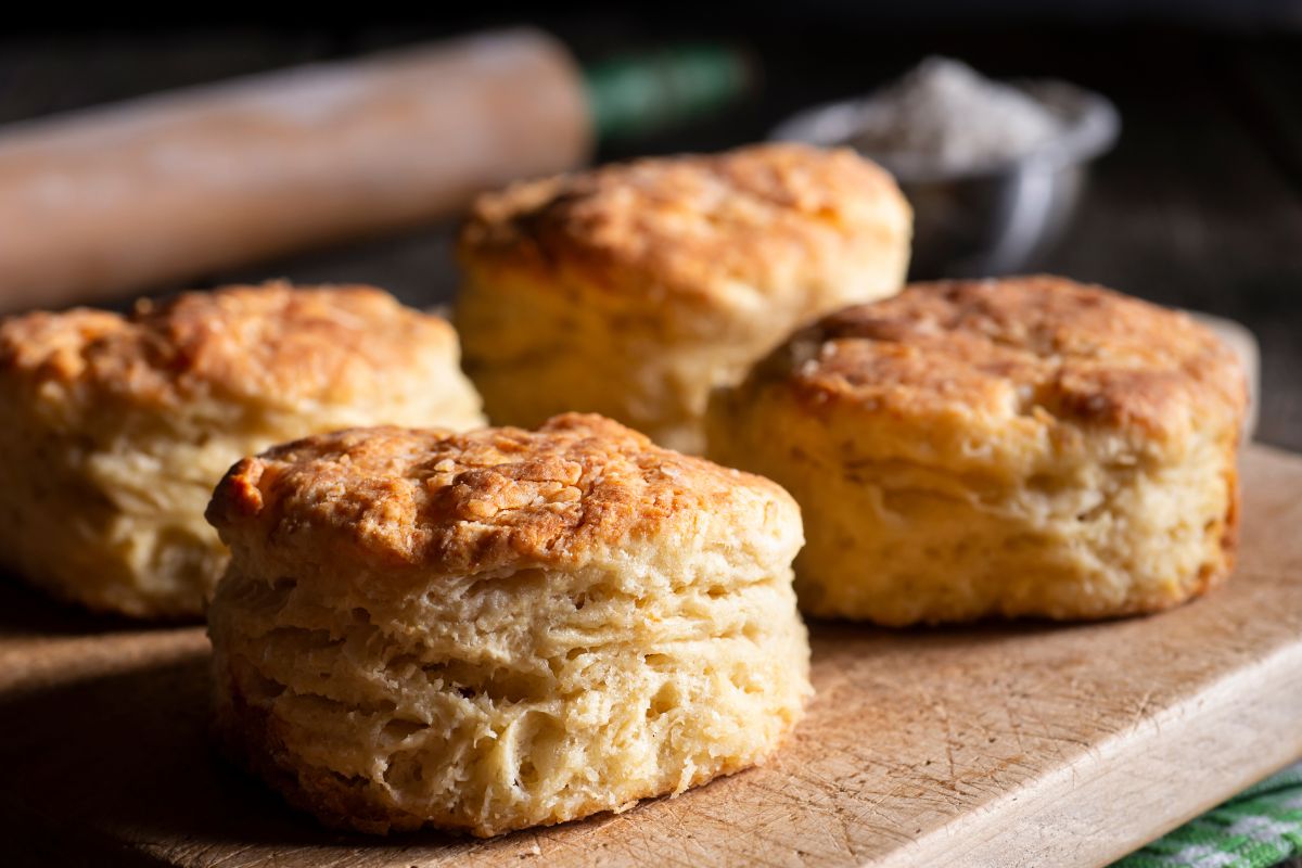 Home baked biscuits set out on a wooden cutting board.