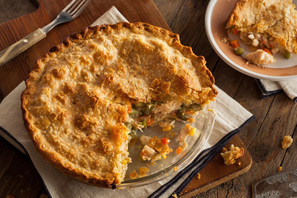 Golden crusted meat pies being cut open for eating.