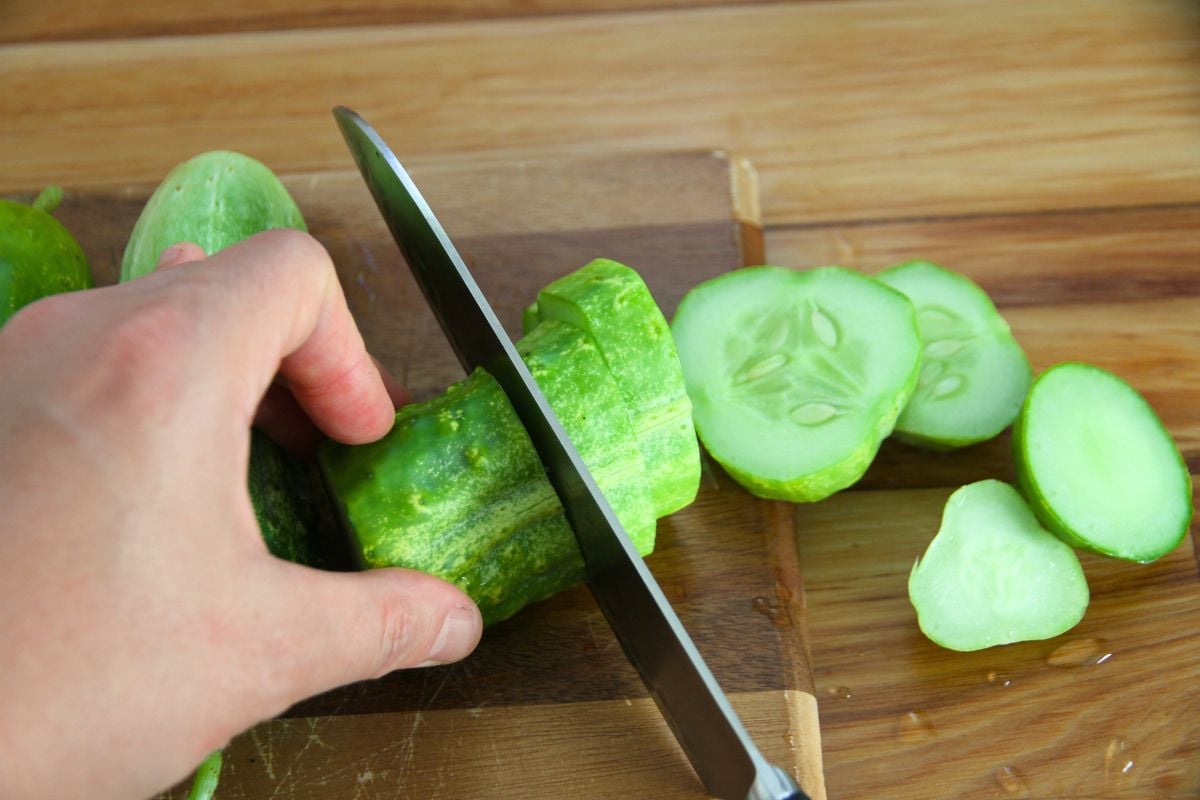 Slicing oversize cucumbers in rings for pickling. 