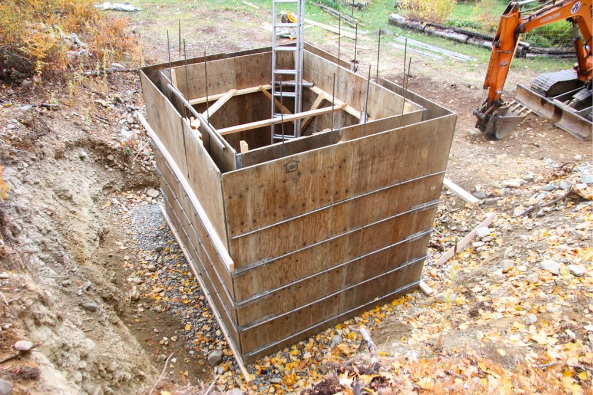 Plywood forms set up for the walls of a concrete root cellar. 