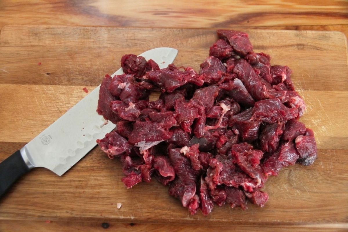 Slicing bear meat into 1 inch cubes for canning.