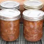 Canned jars of bear meat, cooking on a kitchen counter.